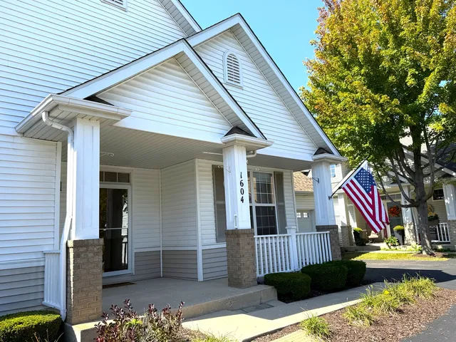 a view of house with yard and outdoor seating