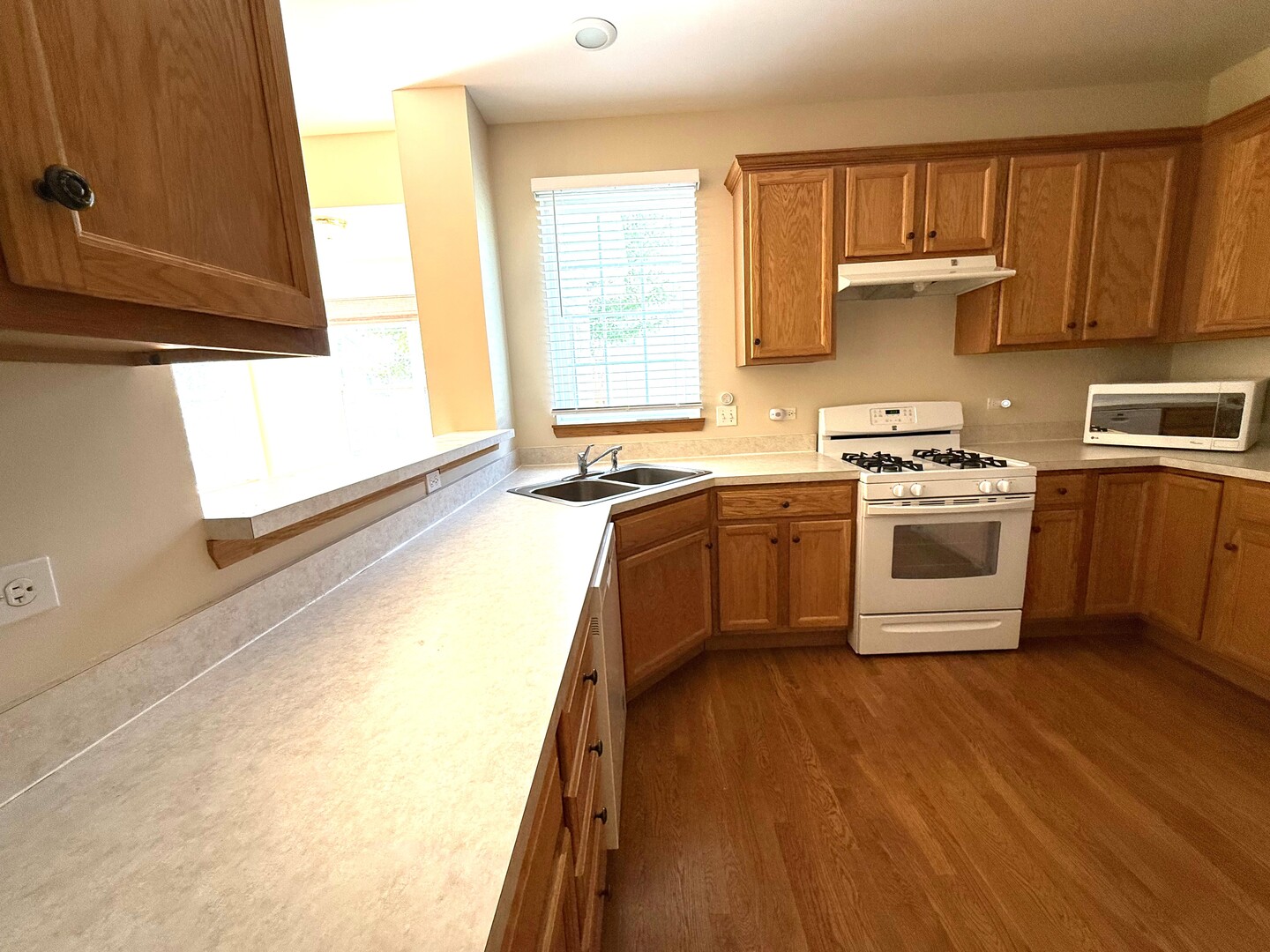1604 Augusta Lane Shorewood, IL 60404 - Photo 10 of 32 a kitchen with a sink a stove and cabinets