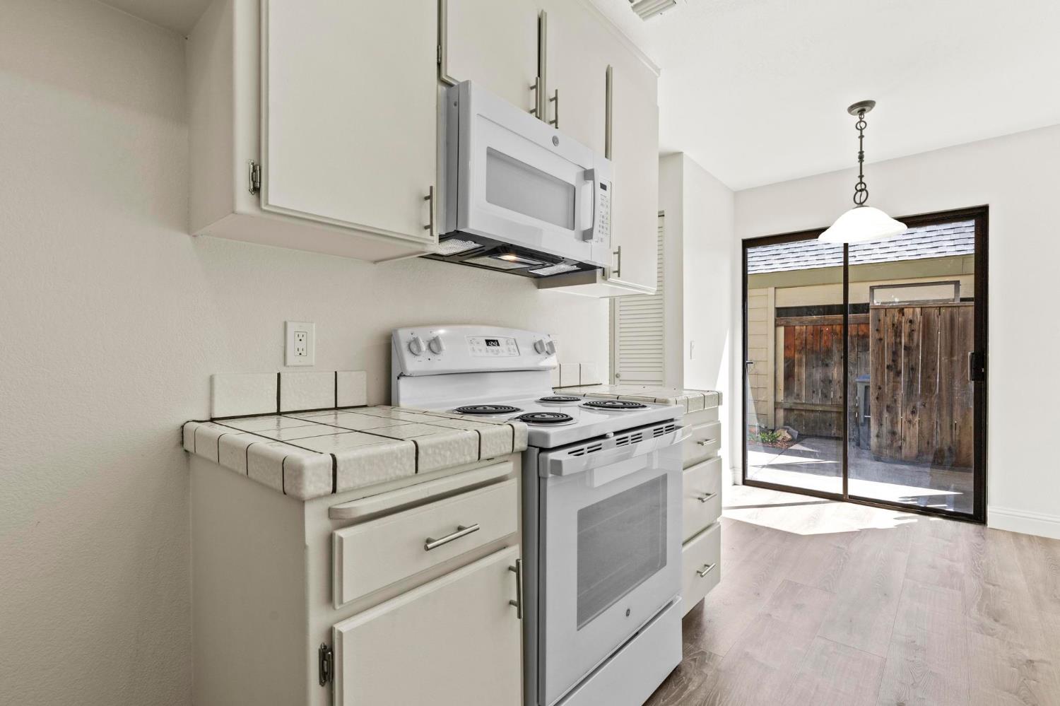 750 Lincoln Road, Unit 82 Yuba City, CA 95991 - Photo 11 of 35 a kitchen with stove cabinets and fan