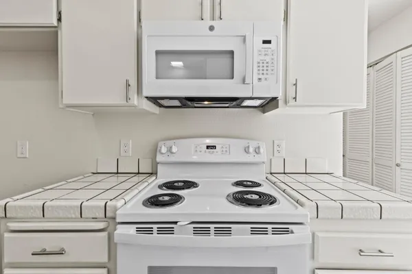 a kitchen with a sink stove and cabinets