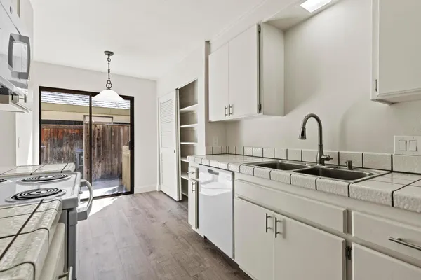 a view of an empty room with a fireplace and a window