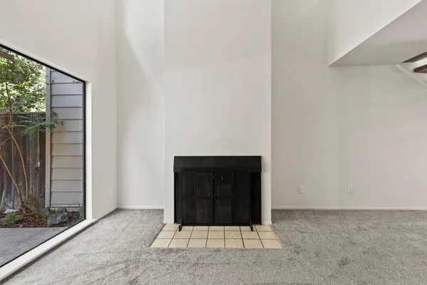 a view of a room with a floor to ceiling window and yard