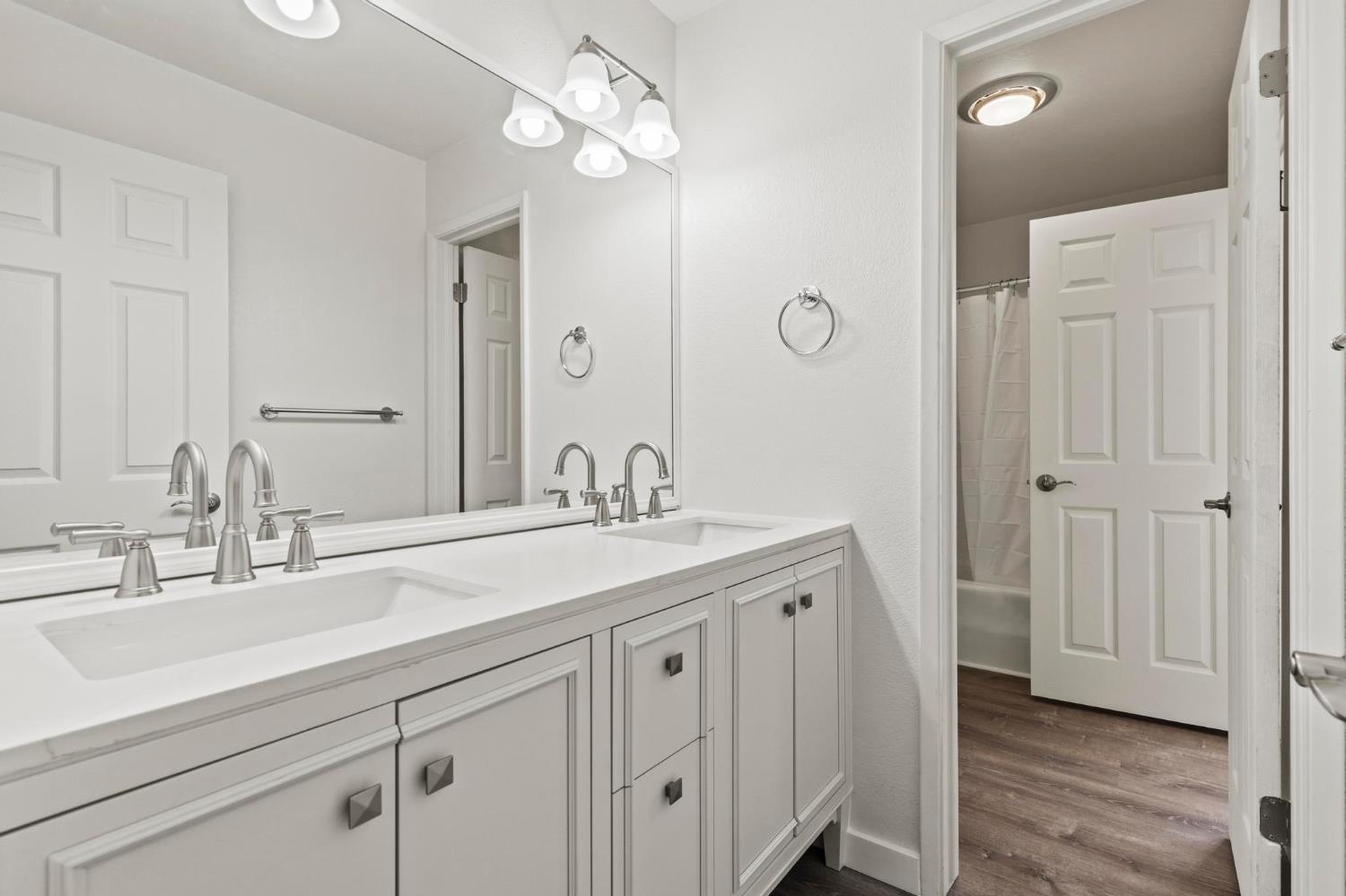 750 Lincoln Road, Unit 82 Yuba City, CA 95991 - Photo 25 of 35 a bathroom with a sink a mirror and a light fixture