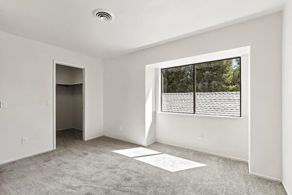 a view of an empty room and closet