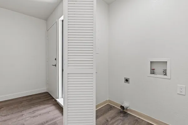 a view of a hallway and wooden floor