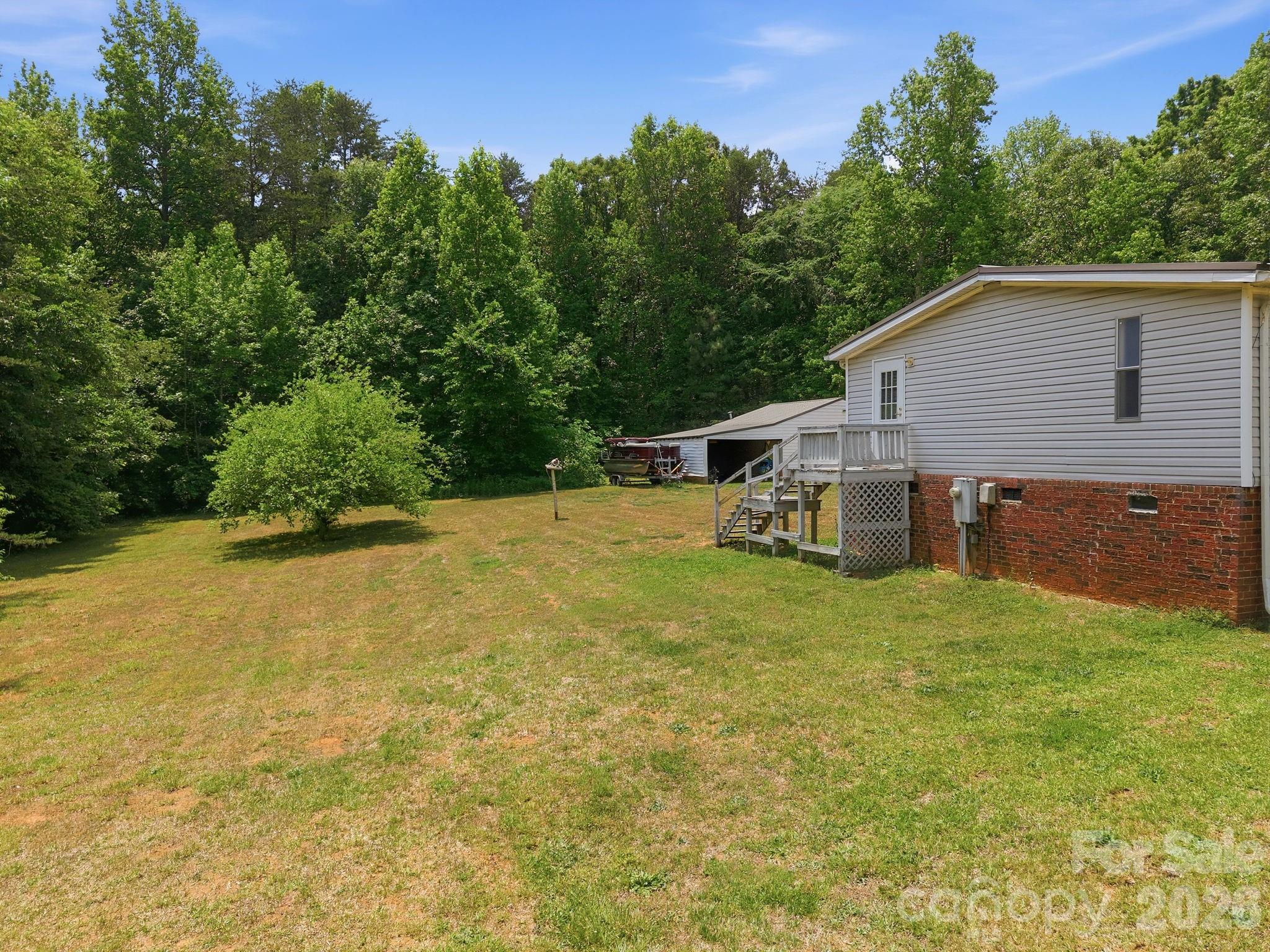 675 Overcash Road Salisbury, NC 28147 - Photo 34 of 48 a backyard of a house with plants and large trees