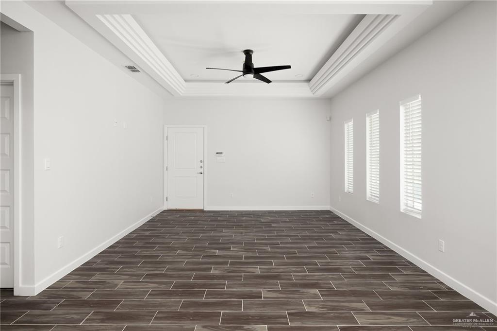 1322 Beverly Avenue Weslaco, TX 78596 - Photo 3 of 17 a view of empty room with wooden floor and fan