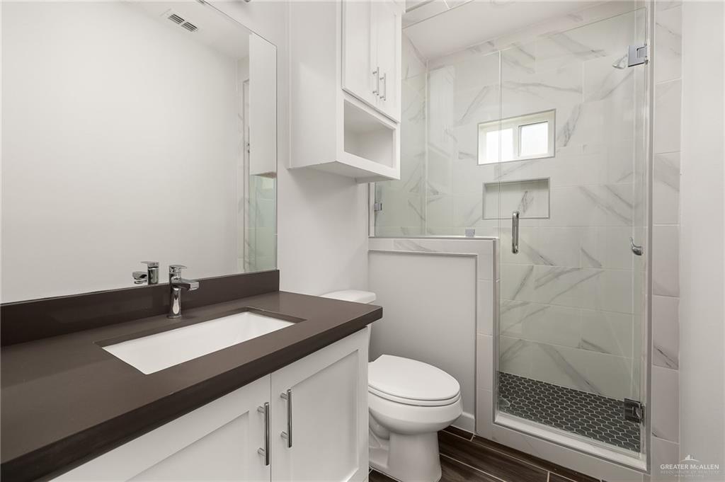 1322 Beverly Avenue Weslaco, TX 78596 - Photo 6 of 17 a bathroom with a sink a toilet and shower