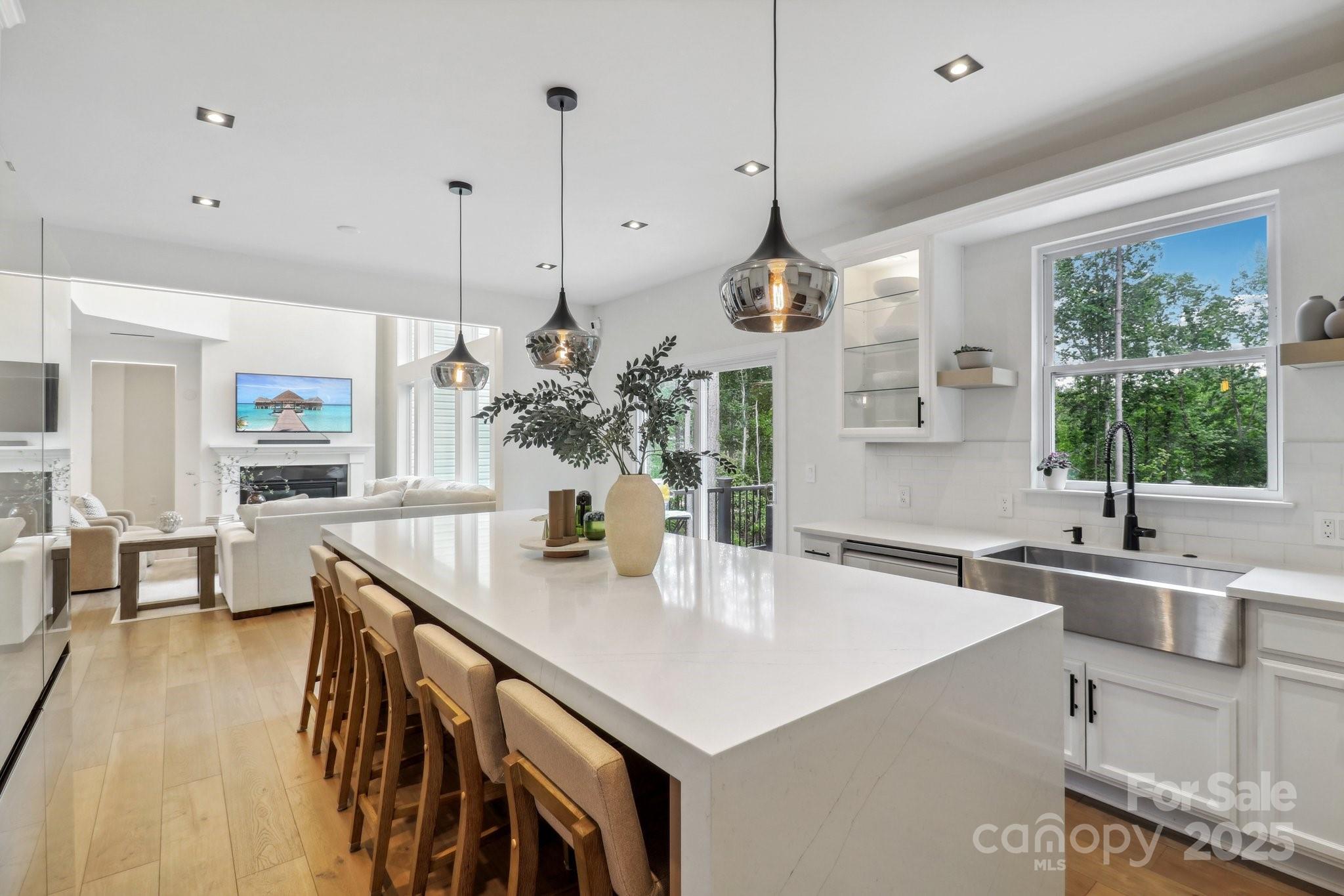 545 Morrison Farm Road Troutman, NC 28166 - Photo 11 of 31 a kitchen with stainless steel appliances granite countertop a sink a center island and cabinets