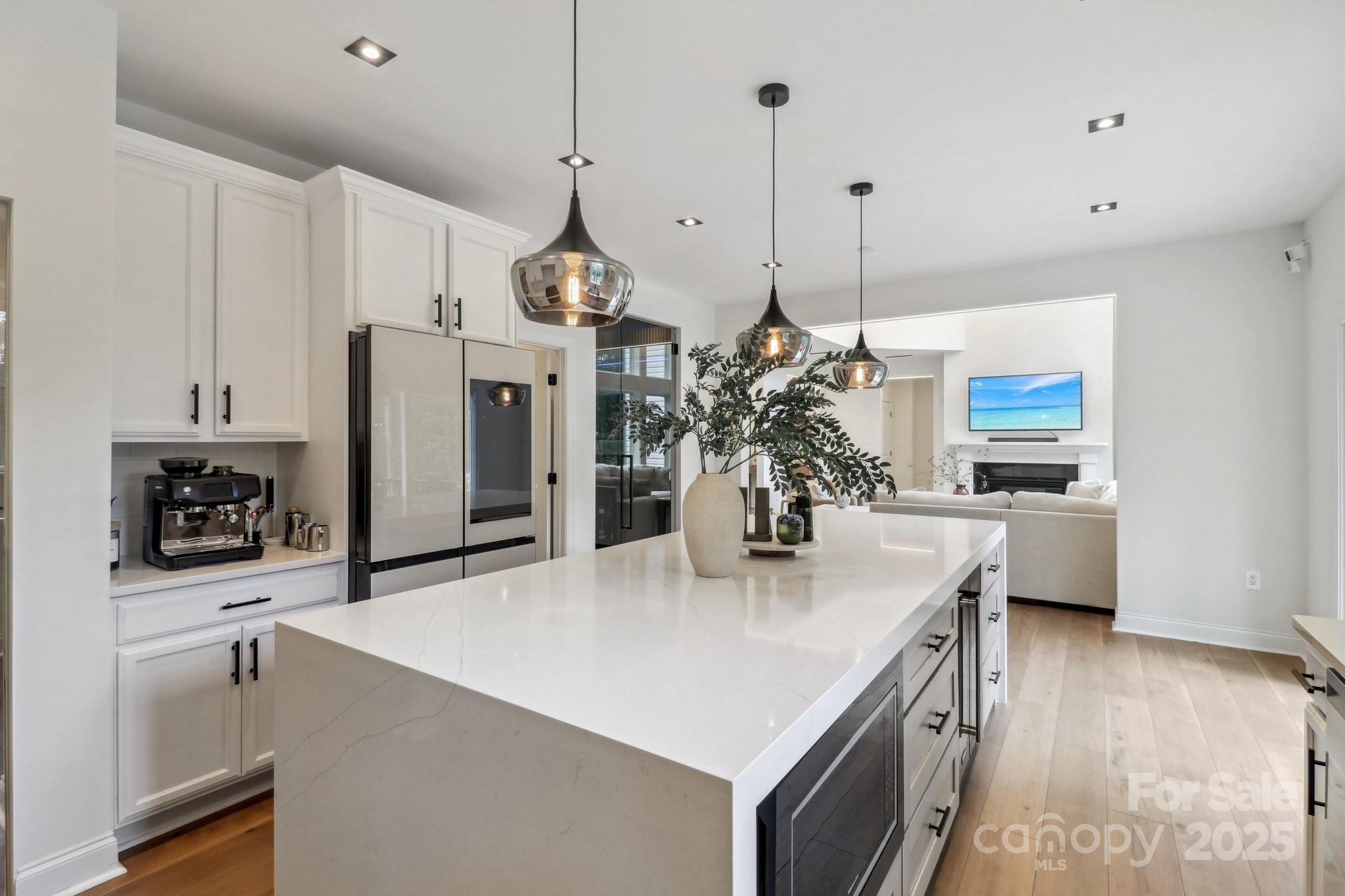 545 Morrison Farm Road Troutman, NC 28166 - Photo 12 of 31 a kitchen with stainless steel appliances granite countertop a sink a refrigerator a stove and a wooden floors