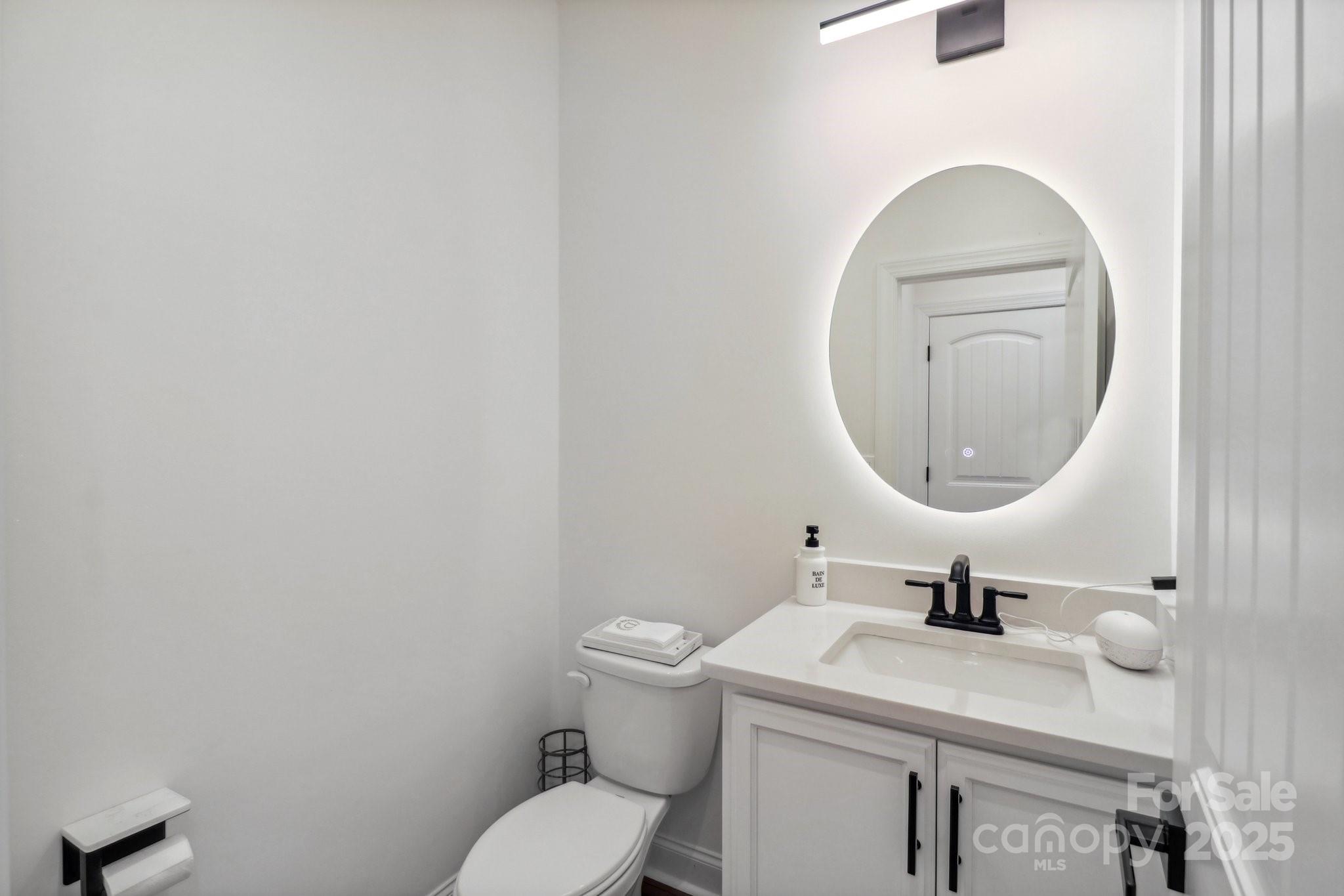 545 Morrison Farm Road Troutman, NC 28166 - Photo 16 of 31 a bathroom with a sink mirror and toilet