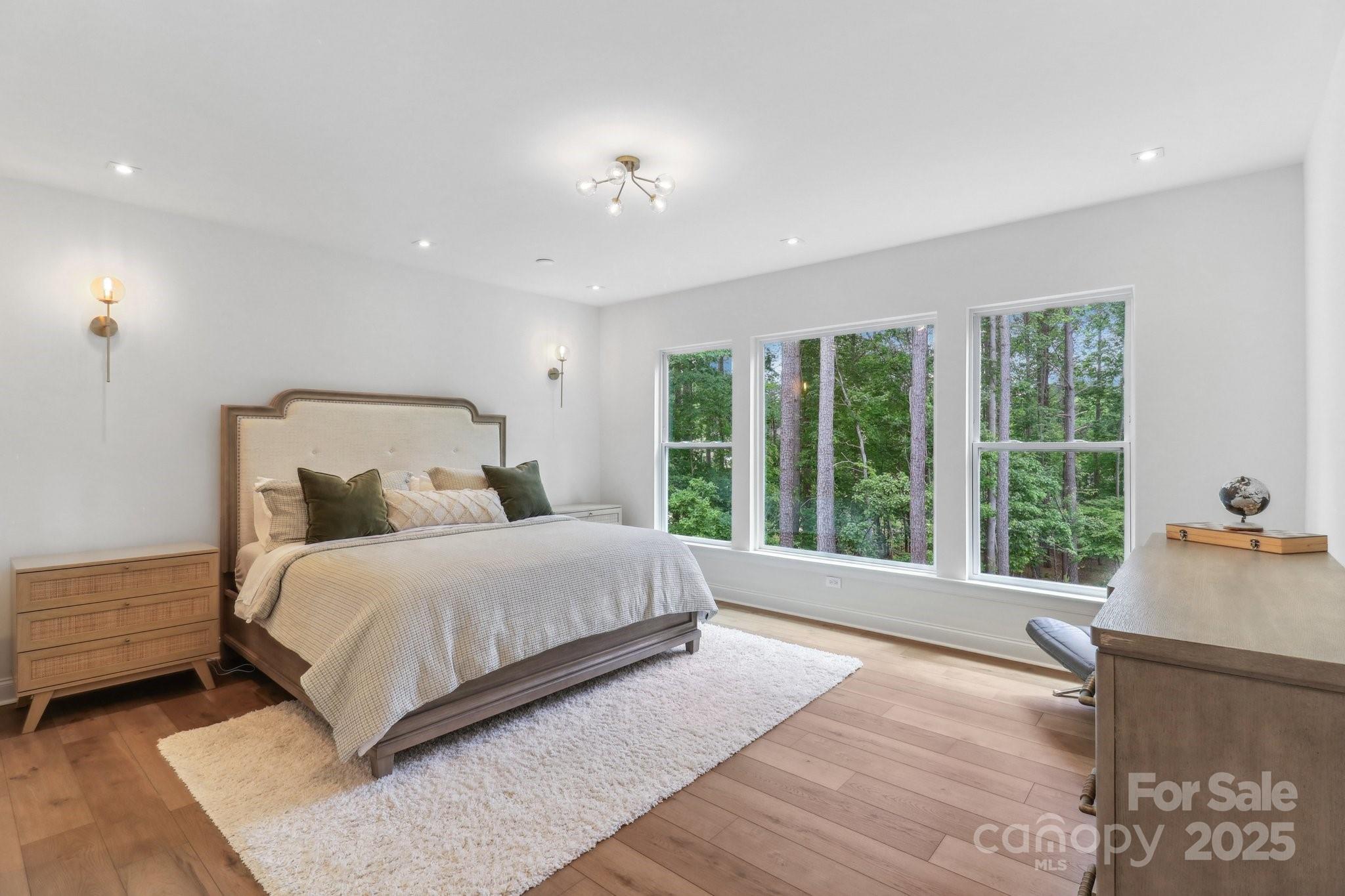 545 Morrison Farm Road Troutman, NC 28166 - Photo 18 of 31 a bedroom with a large bed and large windows