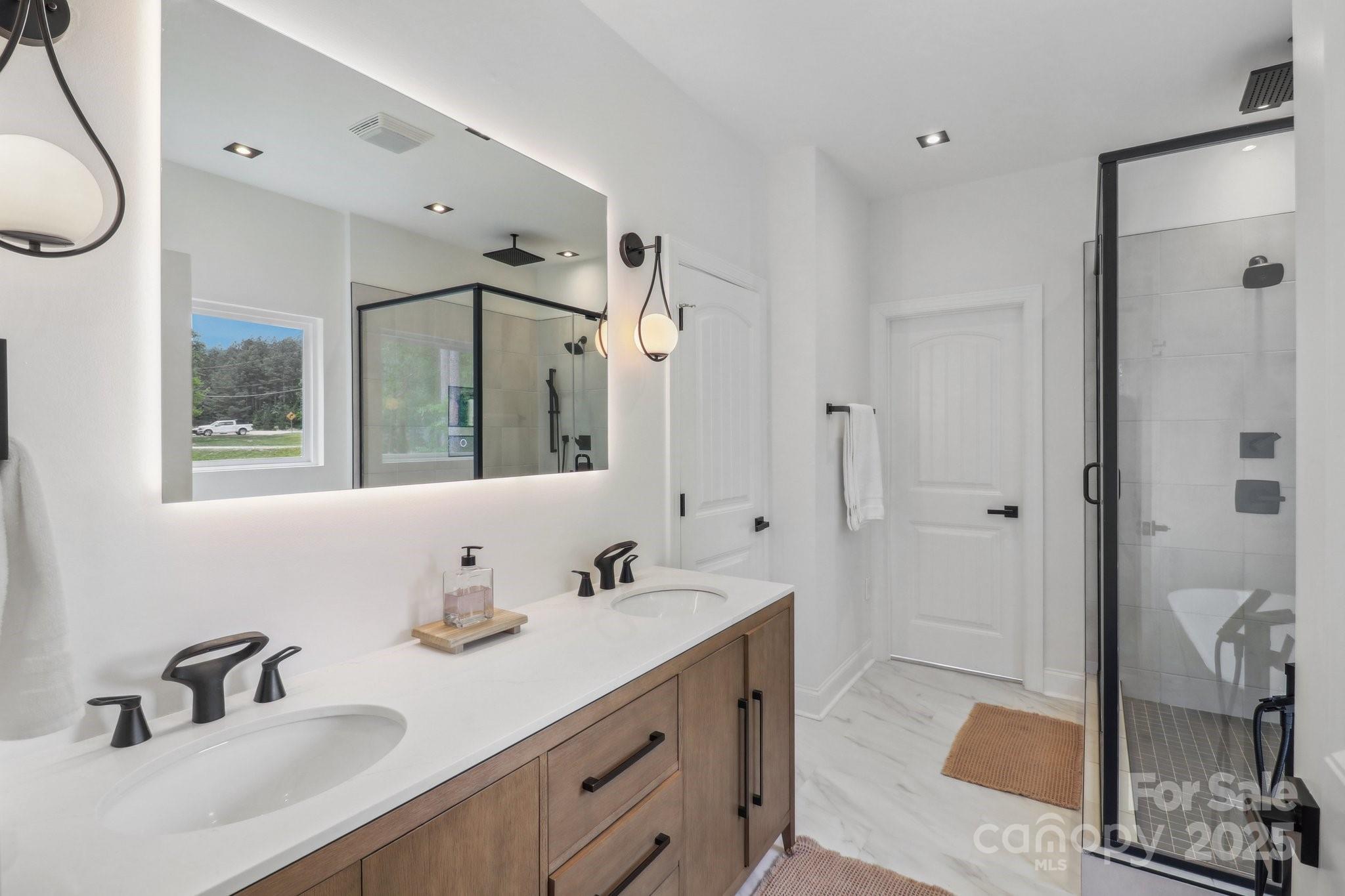545 Morrison Farm Road Troutman, NC 28166 - Photo 20 of 31 a bathroom with a double vanity sink mirror and shower