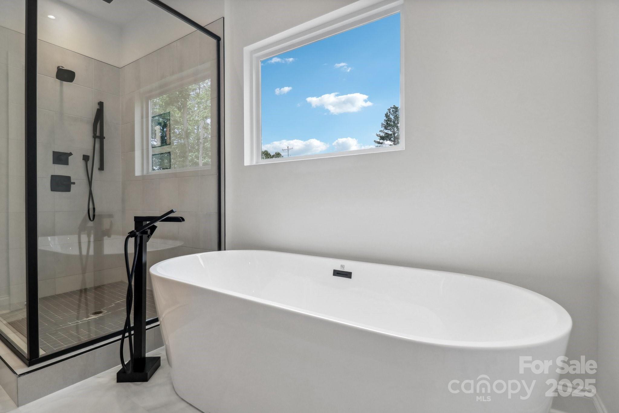 545 Morrison Farm Road Troutman, NC 28166 - Photo 21 of 31 a white bath tub sitting in a bathroom