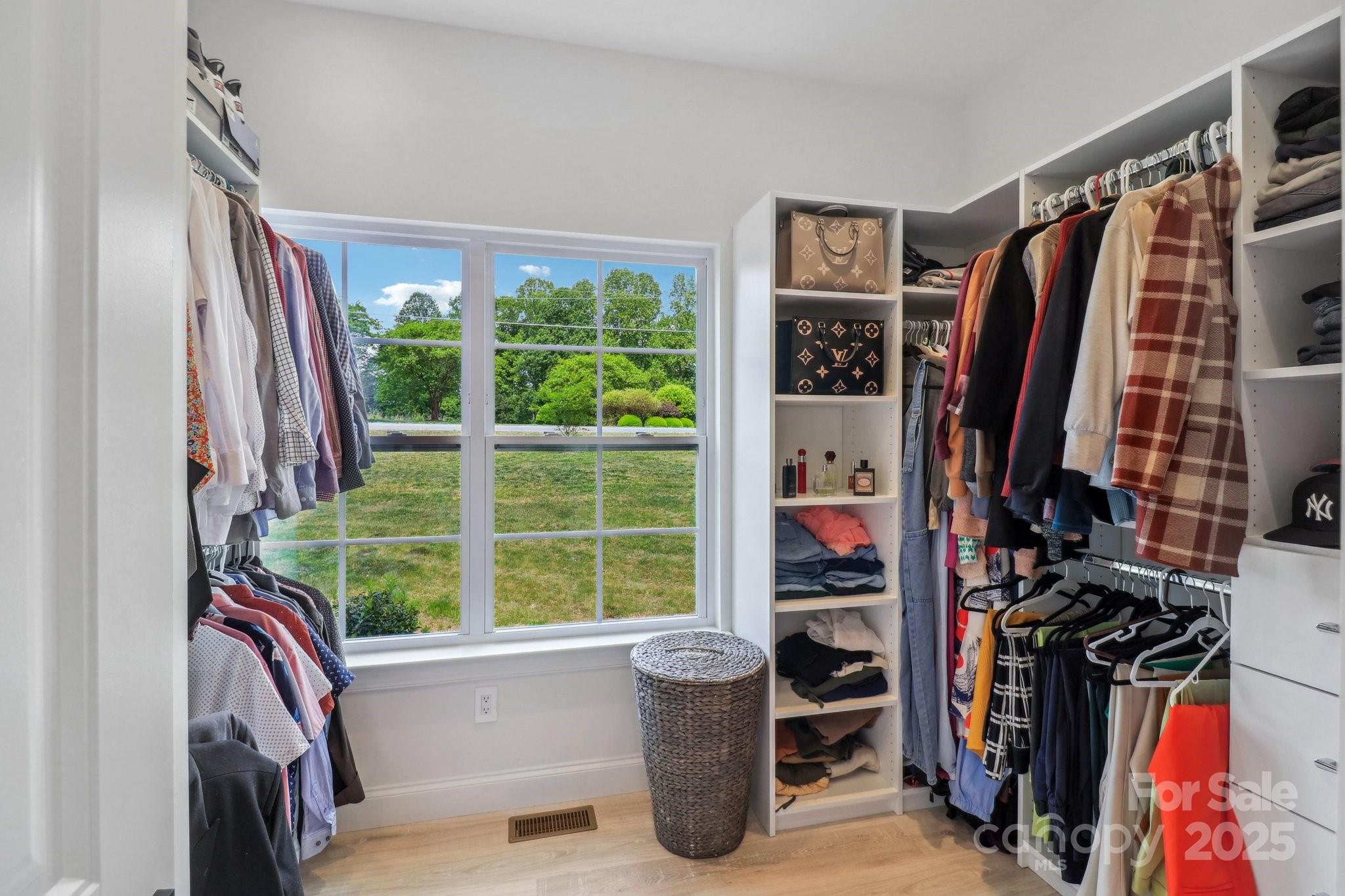 545 Morrison Farm Road Troutman, NC 28166 - Photo 22 of 31 a view of walk in closet with clothes and shoes