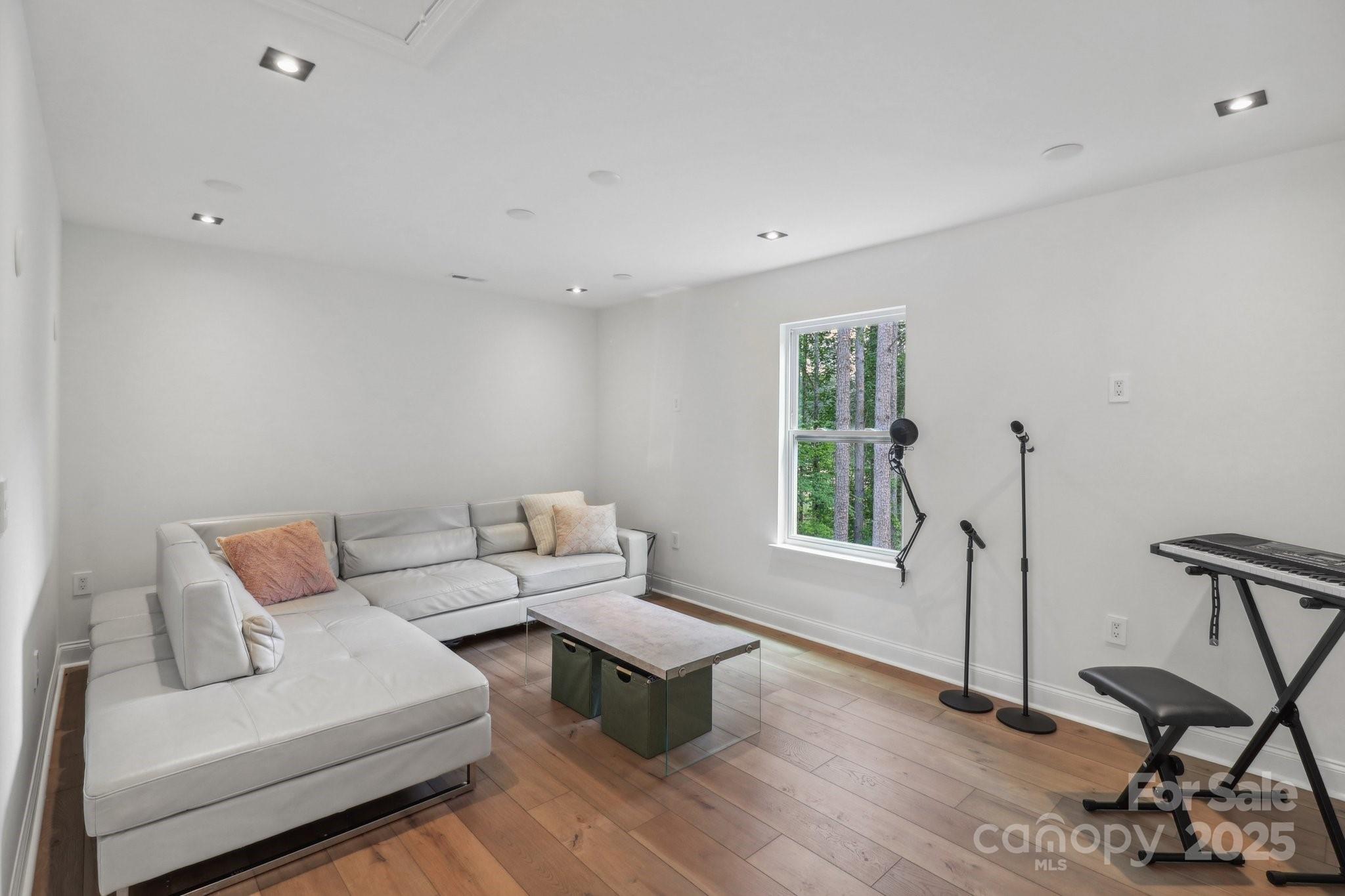 545 Morrison Farm Road Troutman, NC 28166 - Photo 26 of 31 a living room with furniture a window and wooden floor