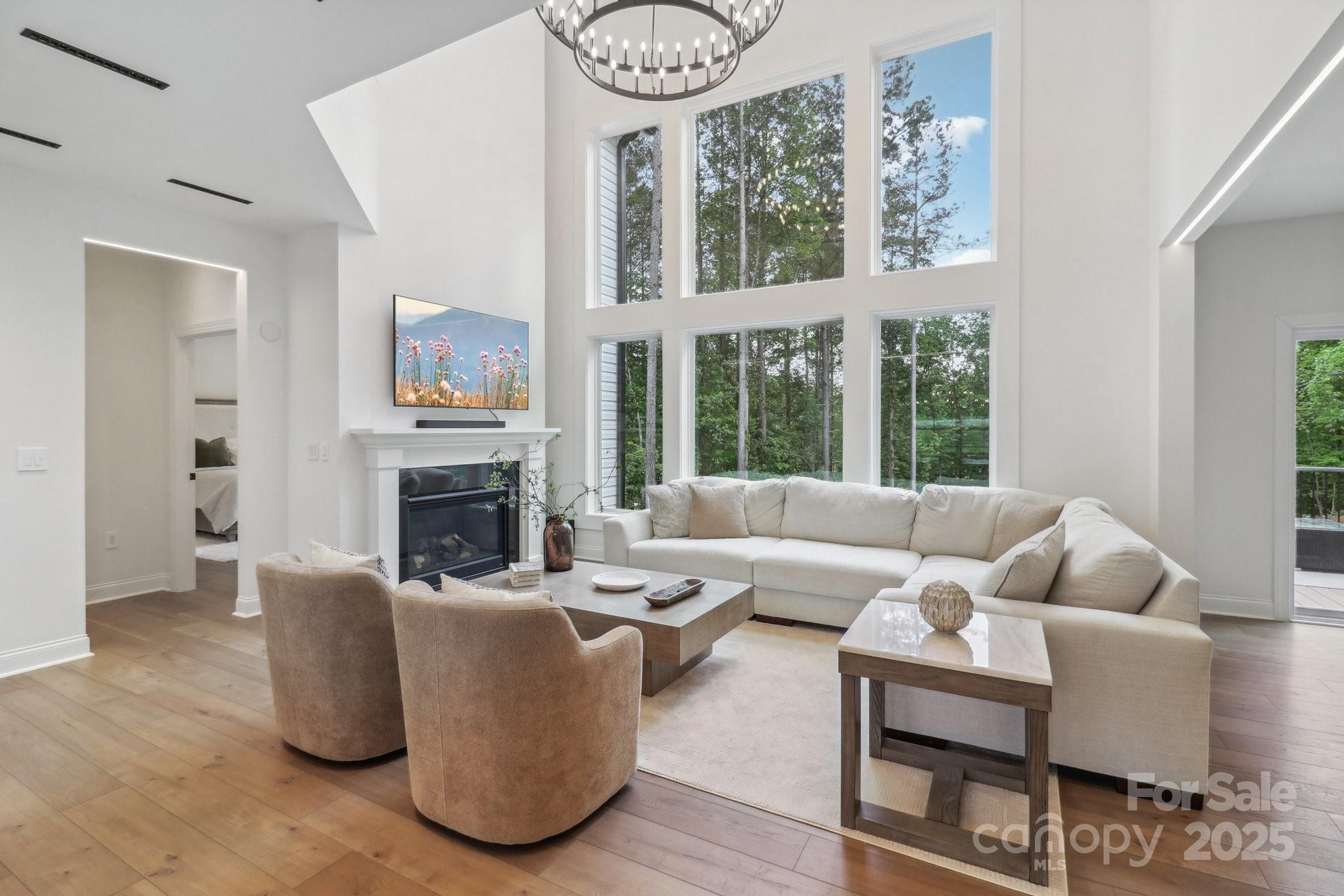 545 Morrison Farm Road Troutman, NC 28166 - Photo 6 of 31 a living room with furniture a fireplace and a large window