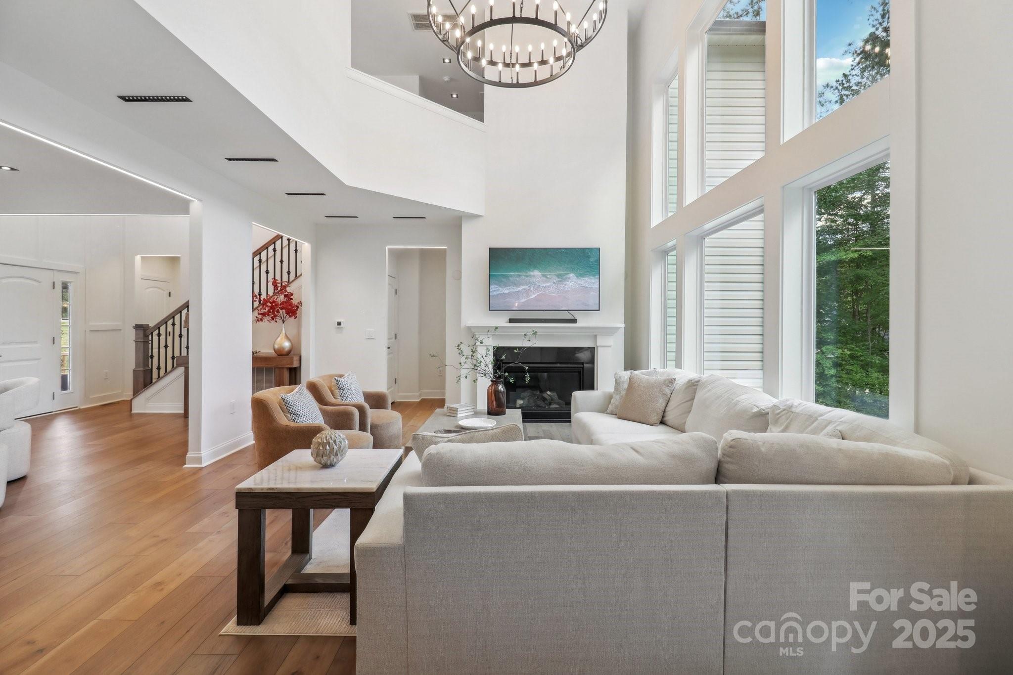 545 Morrison Farm Road Troutman, NC 28166 - Photo 7 of 31 a living room with furniture a fireplace and a large window