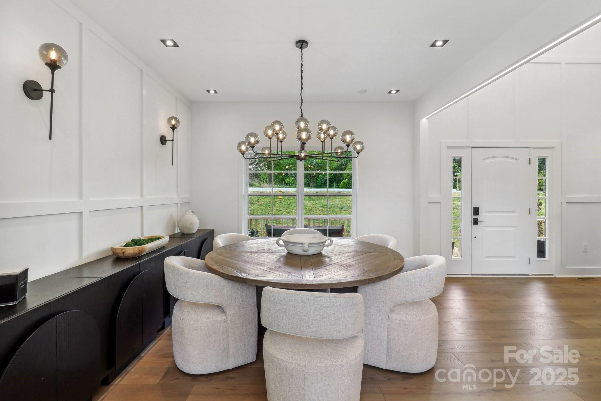 545 Morrison Farm Road Troutman, NC 28166 - Photo 8 of 31 a dining room with furniture a rug and wooden floor