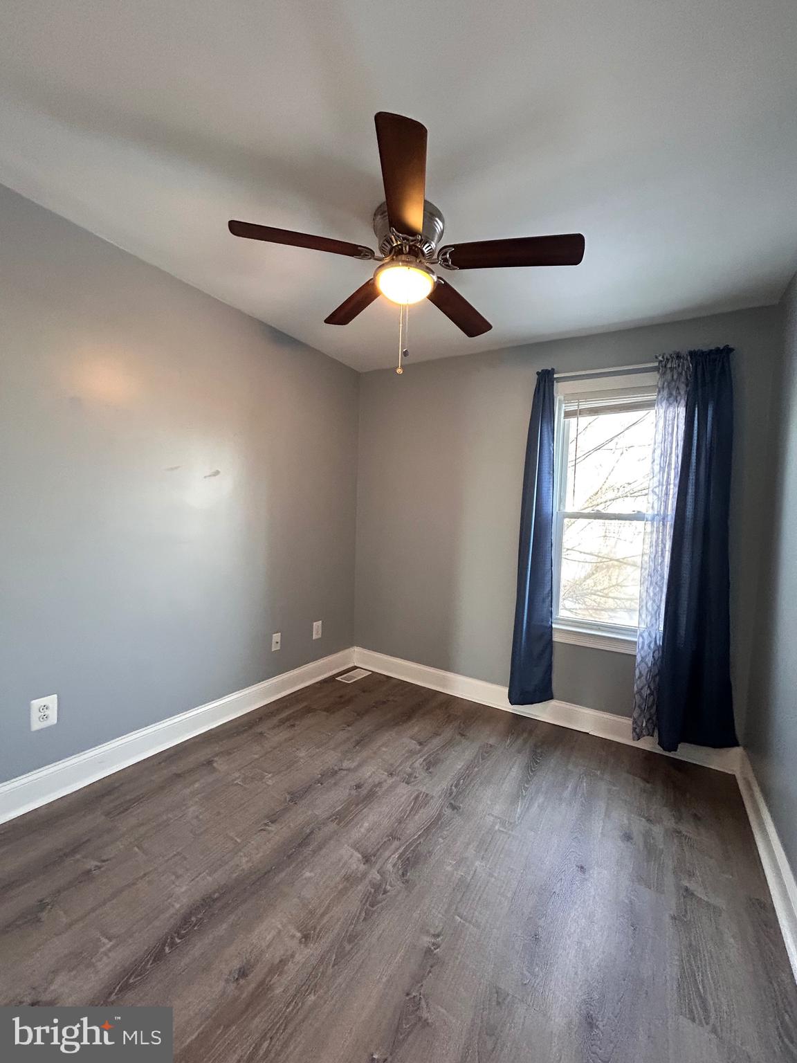 3541 3rd Street Baltimore, MD 21225 - Photo 11 of 37 a view of an empty room with wooden floor and a window