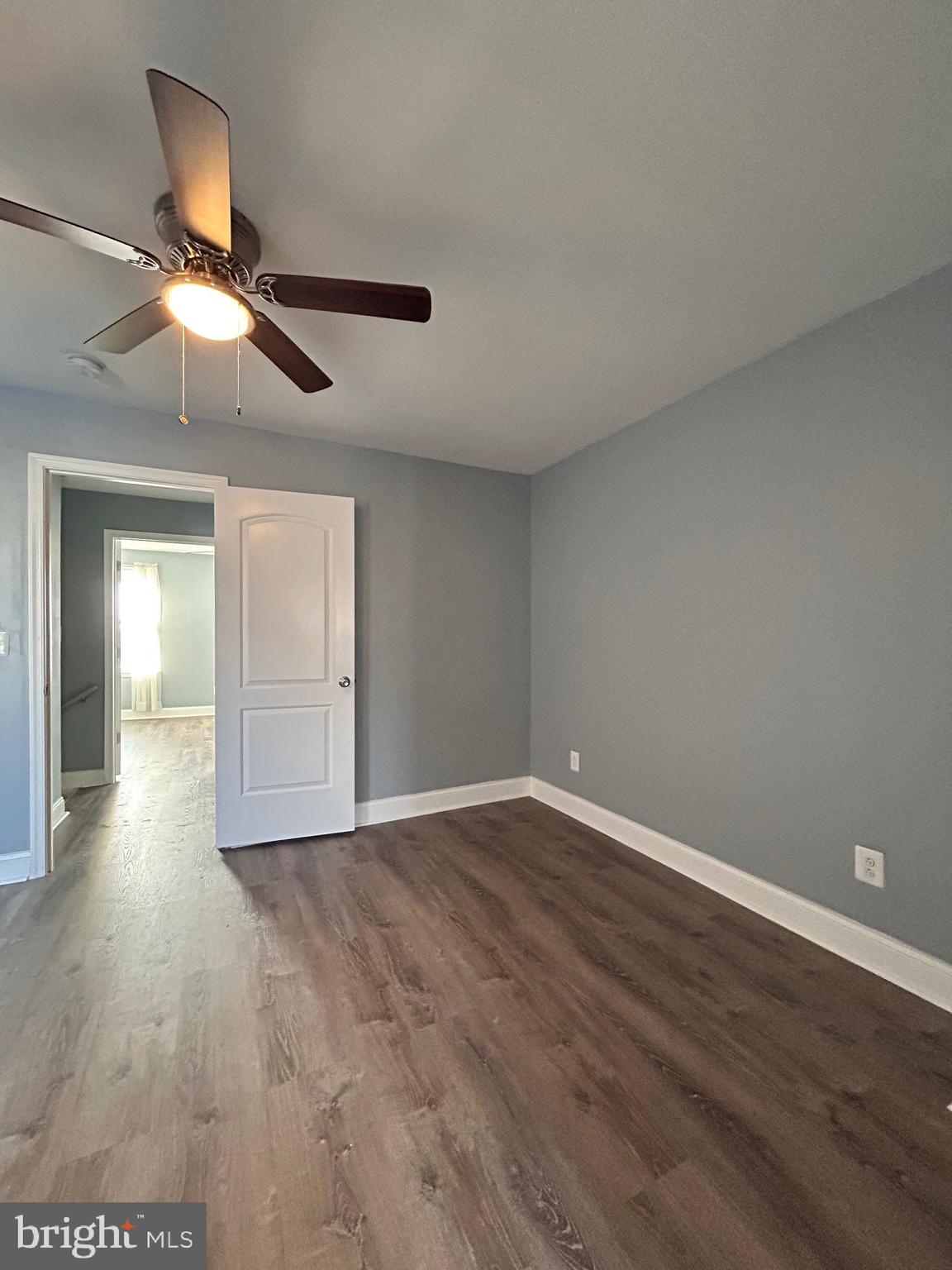 3541 3rd Street Baltimore, MD 21225 - Photo 12 of 37 an empty room with wooden floor ceiling fan and windows