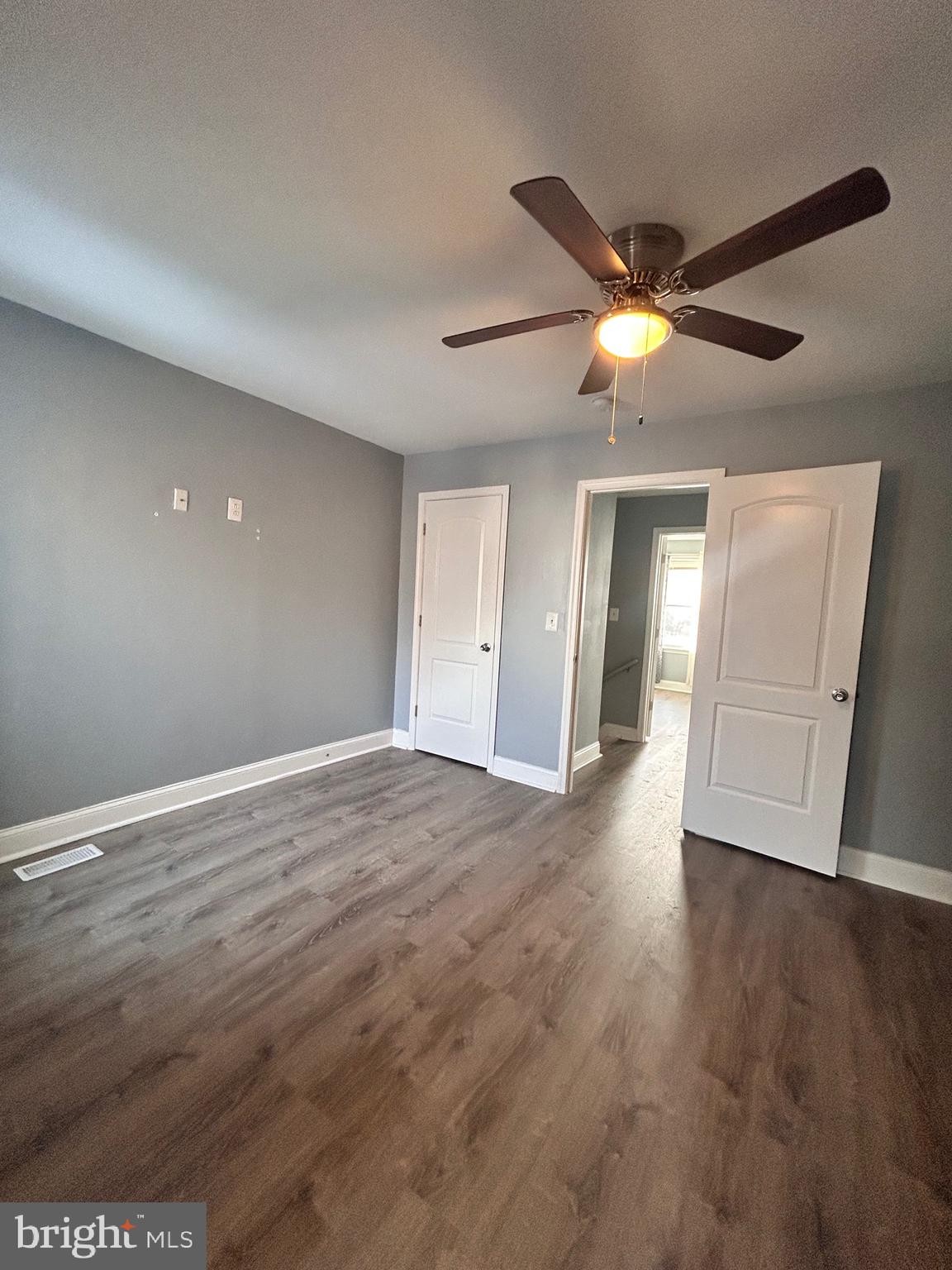 3541 3rd Street Baltimore, MD 21225 - Photo 13 of 37 a view of an empty room with wooden floor and a ceiling fan