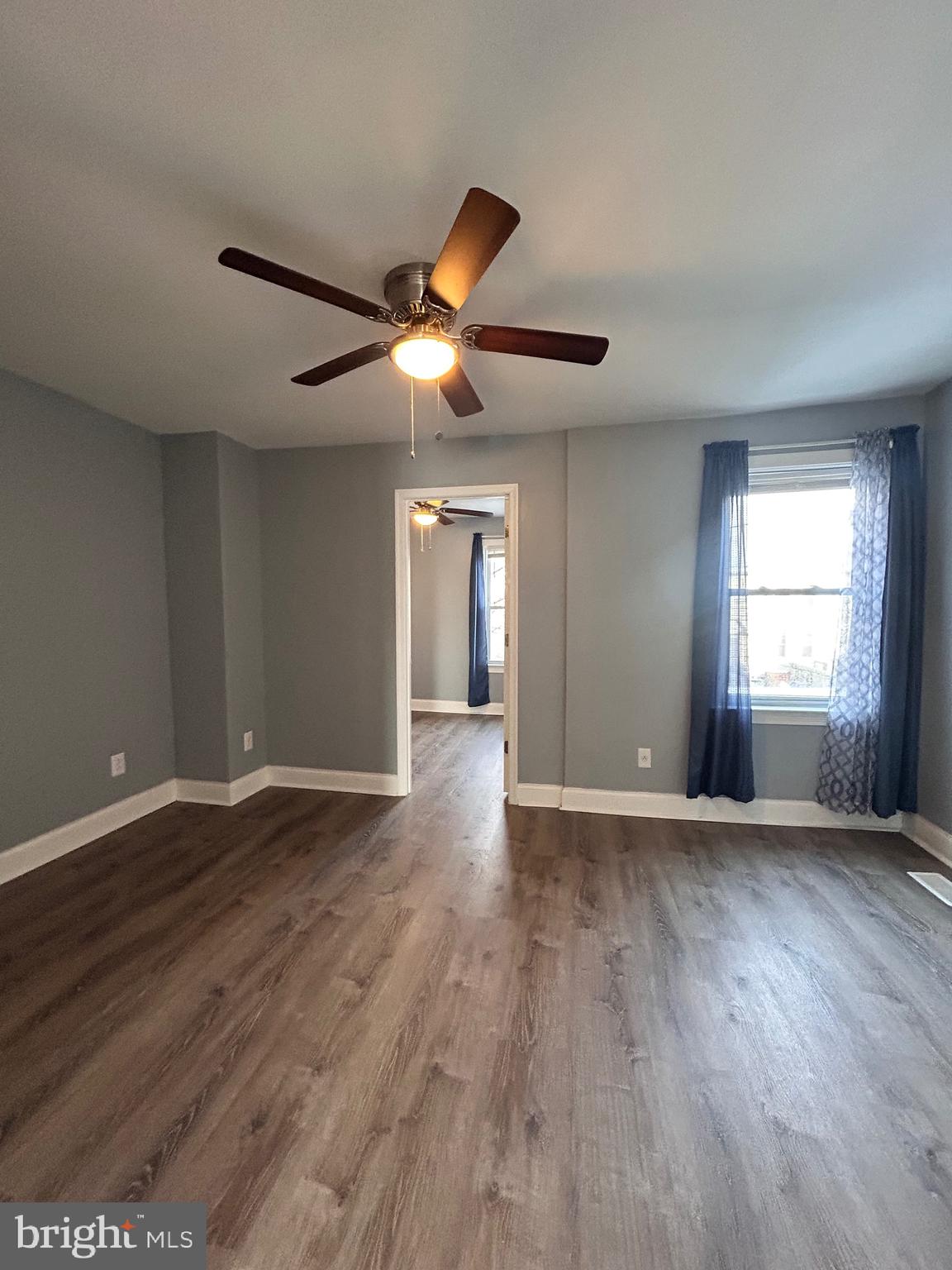 3541 3rd Street Baltimore, MD 21225 - Photo 15 of 37 a view of an empty room with window and wooden floor