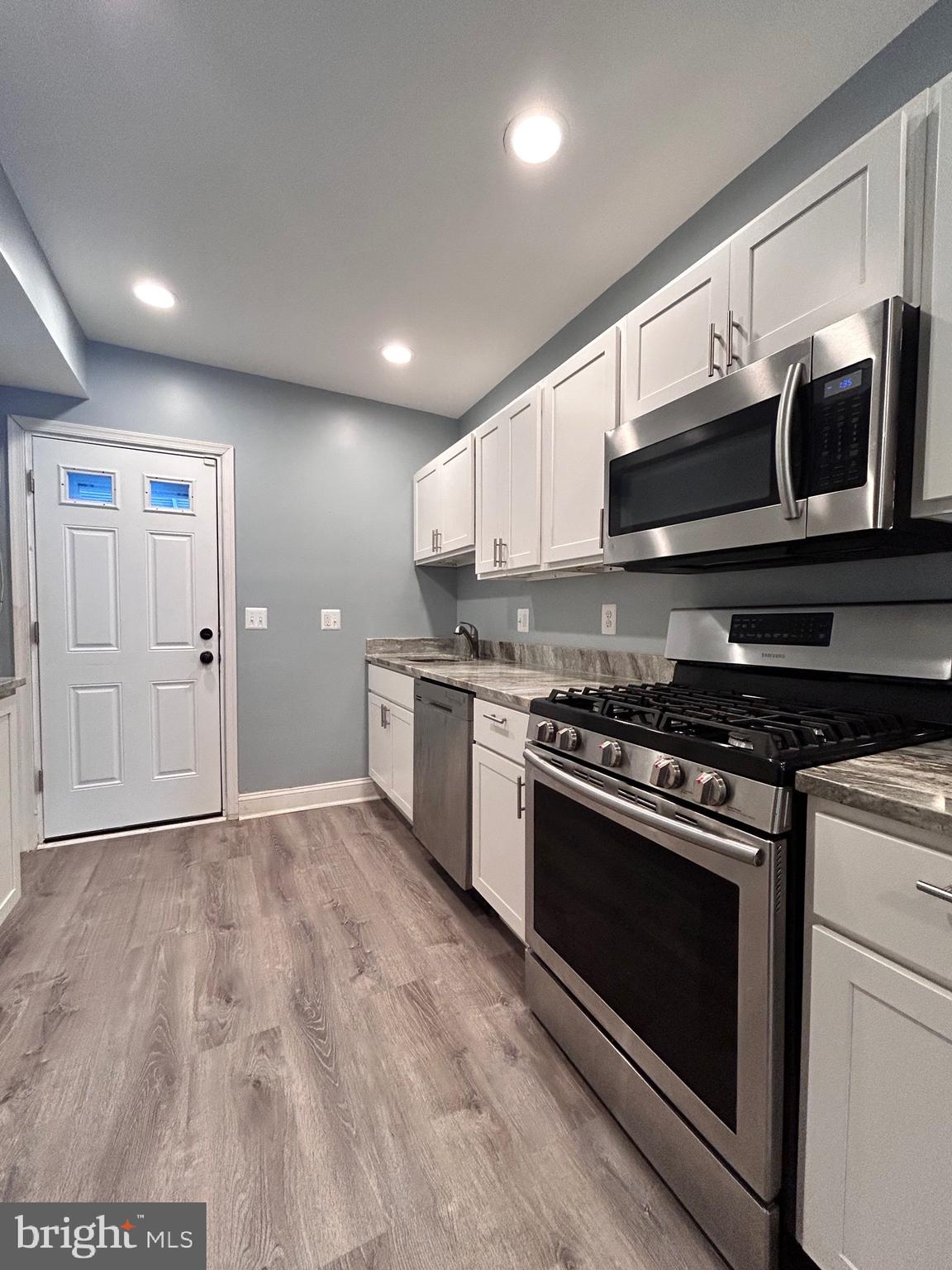 3541 3rd Street Baltimore, MD 21225 - Photo 4 of 37 a kitchen with stainless steel appliances granite countertop a stove and a microwave