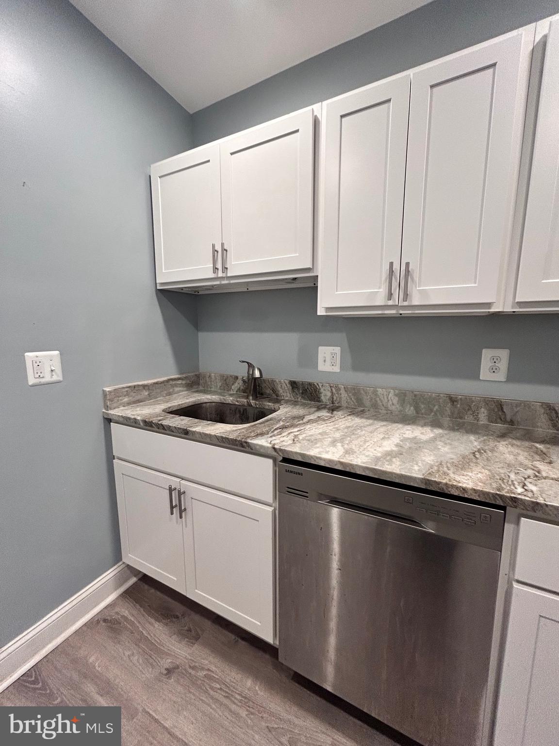 3541 3rd Street Baltimore, MD 21225 - Photo 6 of 37 a kitchen with granite countertop white cabinets and a sink
