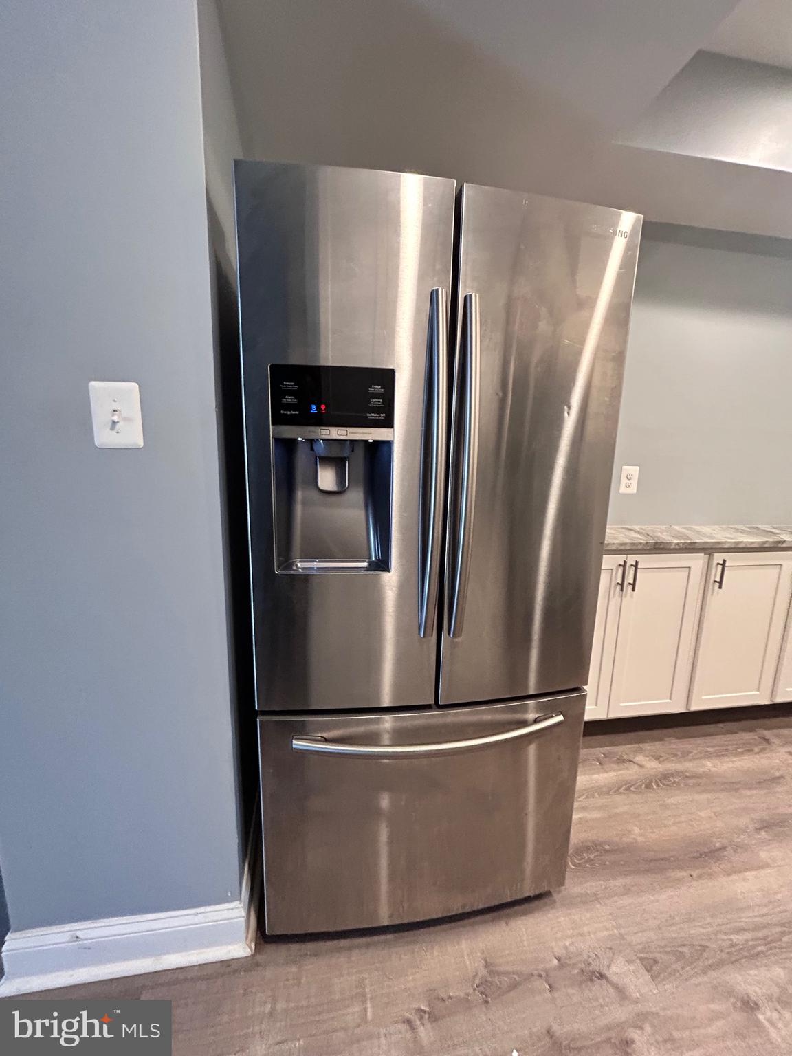3541 3rd Street Baltimore, MD 21225 - Photo 8 of 37 a view of metallic refrigerator with wooden floor