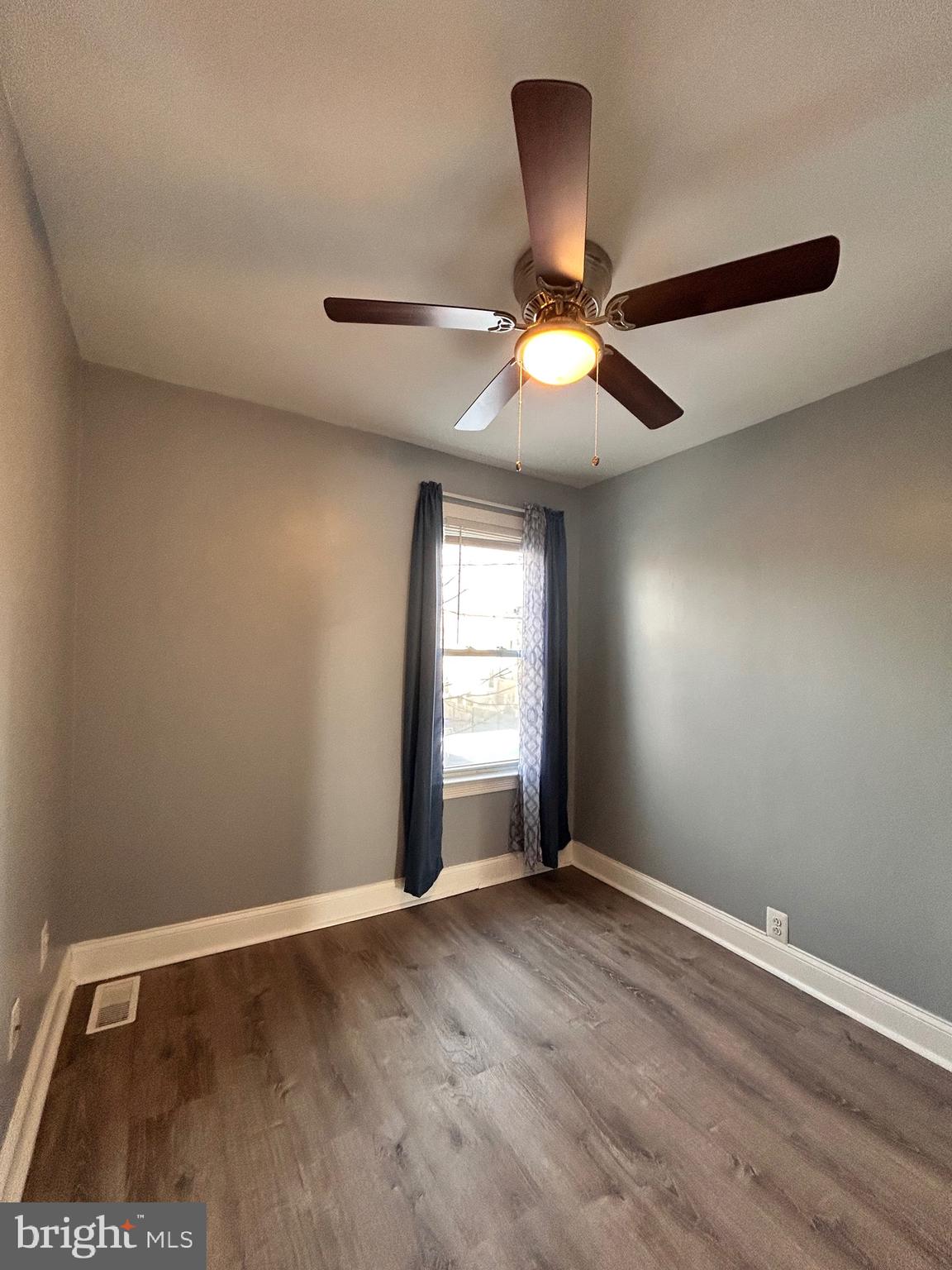 3541 3rd Street Baltimore, MD 21225 - Photo 9 of 37 a view of an empty room with window and wooden floor