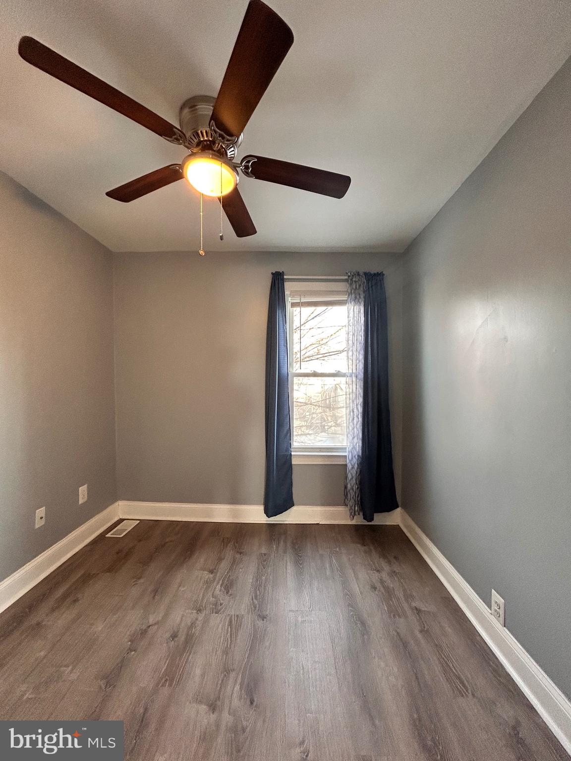 3541 3rd Street Baltimore, MD 21225 - Photo 10 of 37 an empty room with wooden floor fan and windows