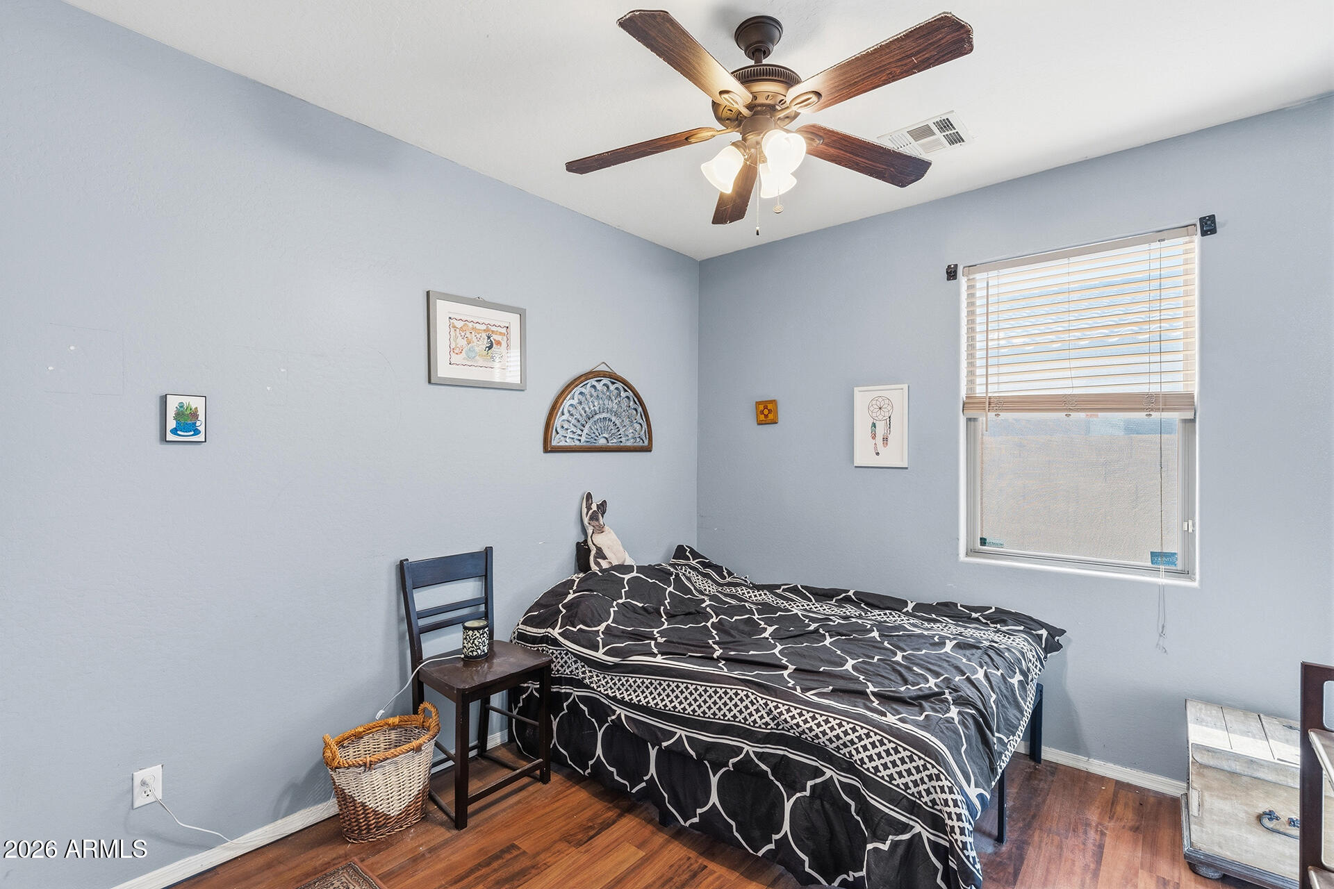 6718 West Darrel Road Laveen, AZ 85339 - Photo 16 of 49 a bed sitting in a bedroom next to a window