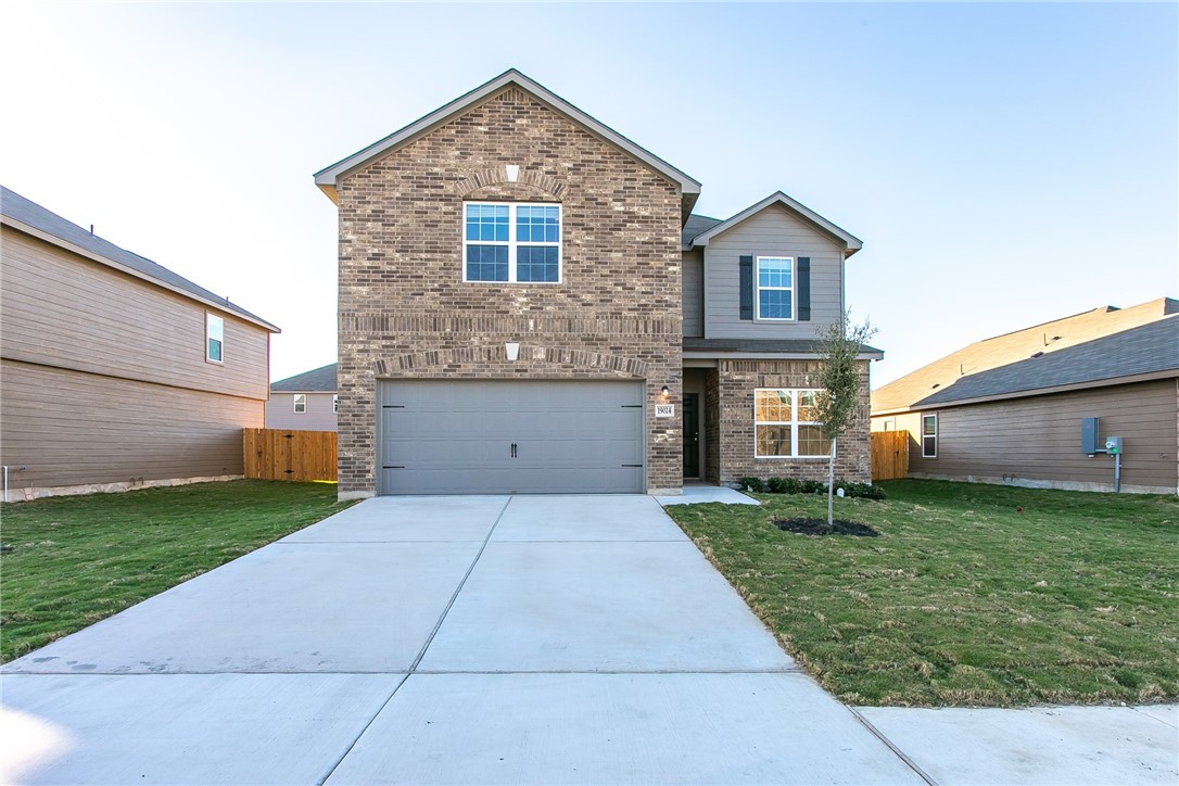 19024 Quiet Range Drive Elgin, TX 78621 - Photo 1 of 30 a front view of a house with a yard and garage