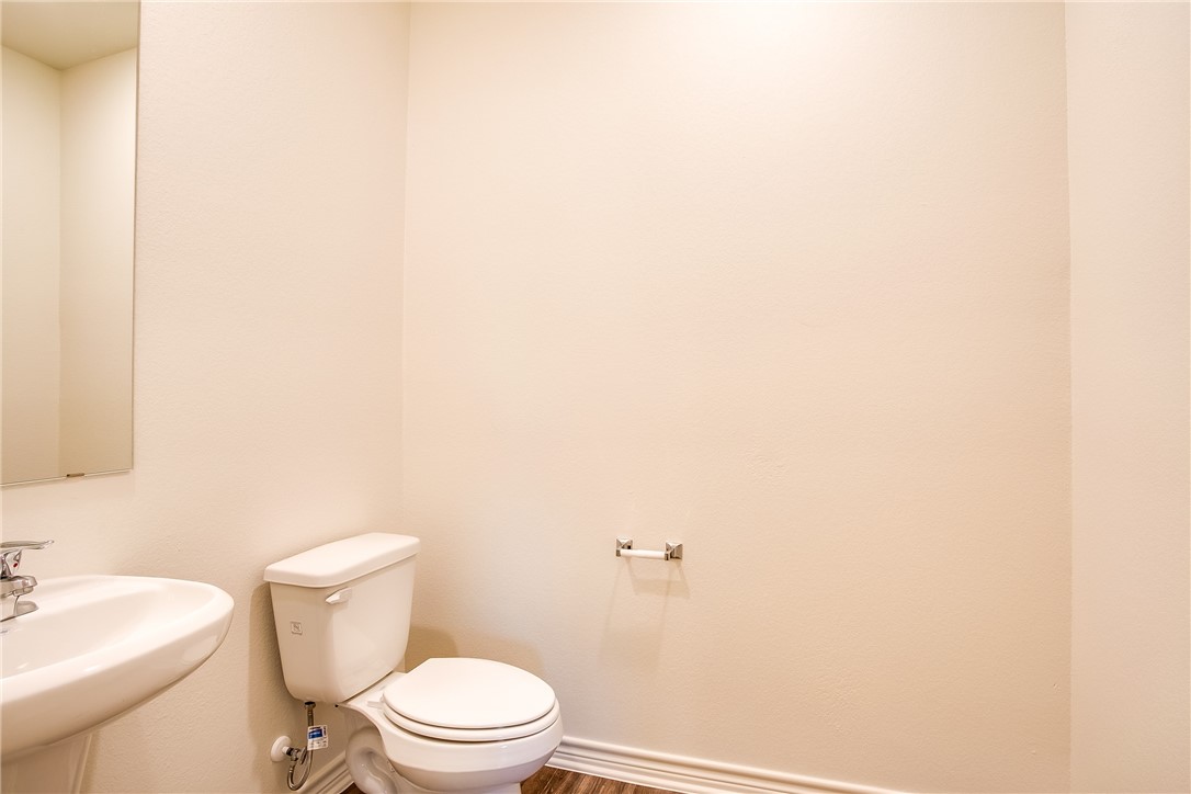 19024 Quiet Range Drive Elgin, TX 78621 - Photo 12 of 30 a white toilet sitting next to a white sink