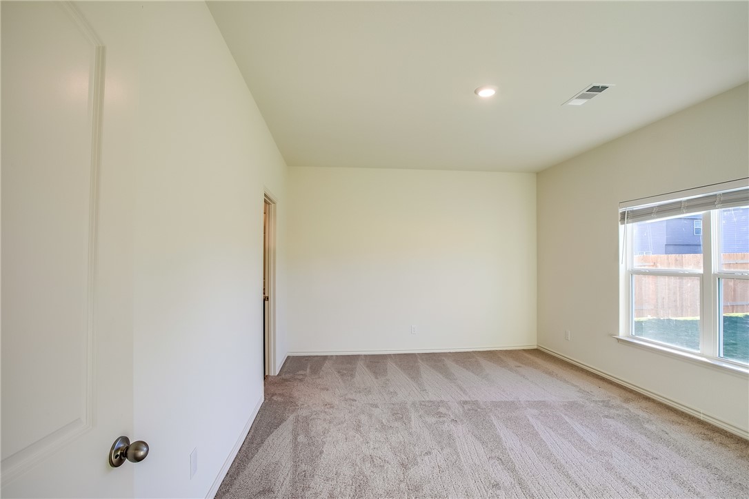 19024 Quiet Range Drive Elgin, TX 78621 - Photo 13 of 30 wooden floor in an empty room with a window