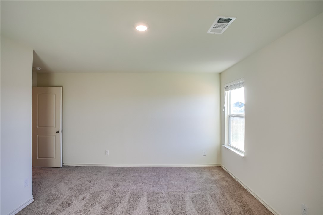 19024 Quiet Range Drive Elgin, TX 78621 - Photo 20 of 30 an empty room with windows and closet