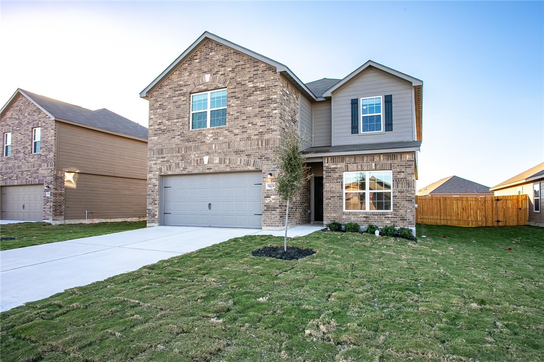 19024 Quiet Range Drive Elgin, TX 78621 - Photo 2 of 30 a front view of a house with a yard and garage