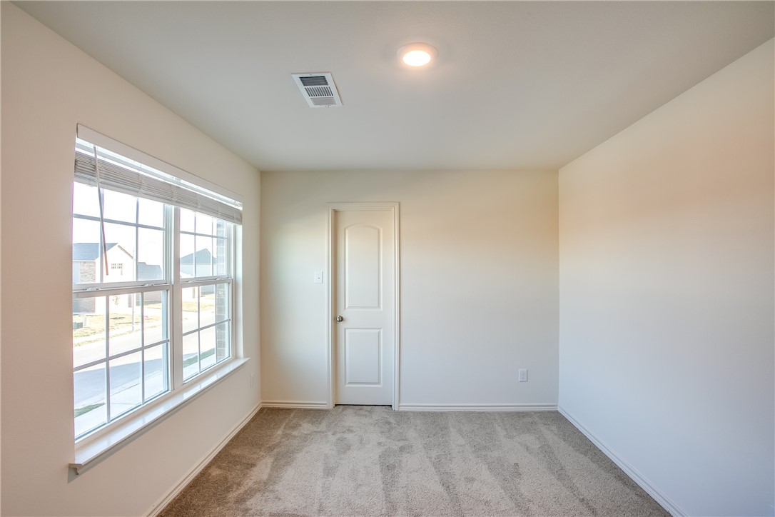 19024 Quiet Range Drive Elgin, TX 78621 - Photo 24 of 30 an empty room with wooden floor and windows