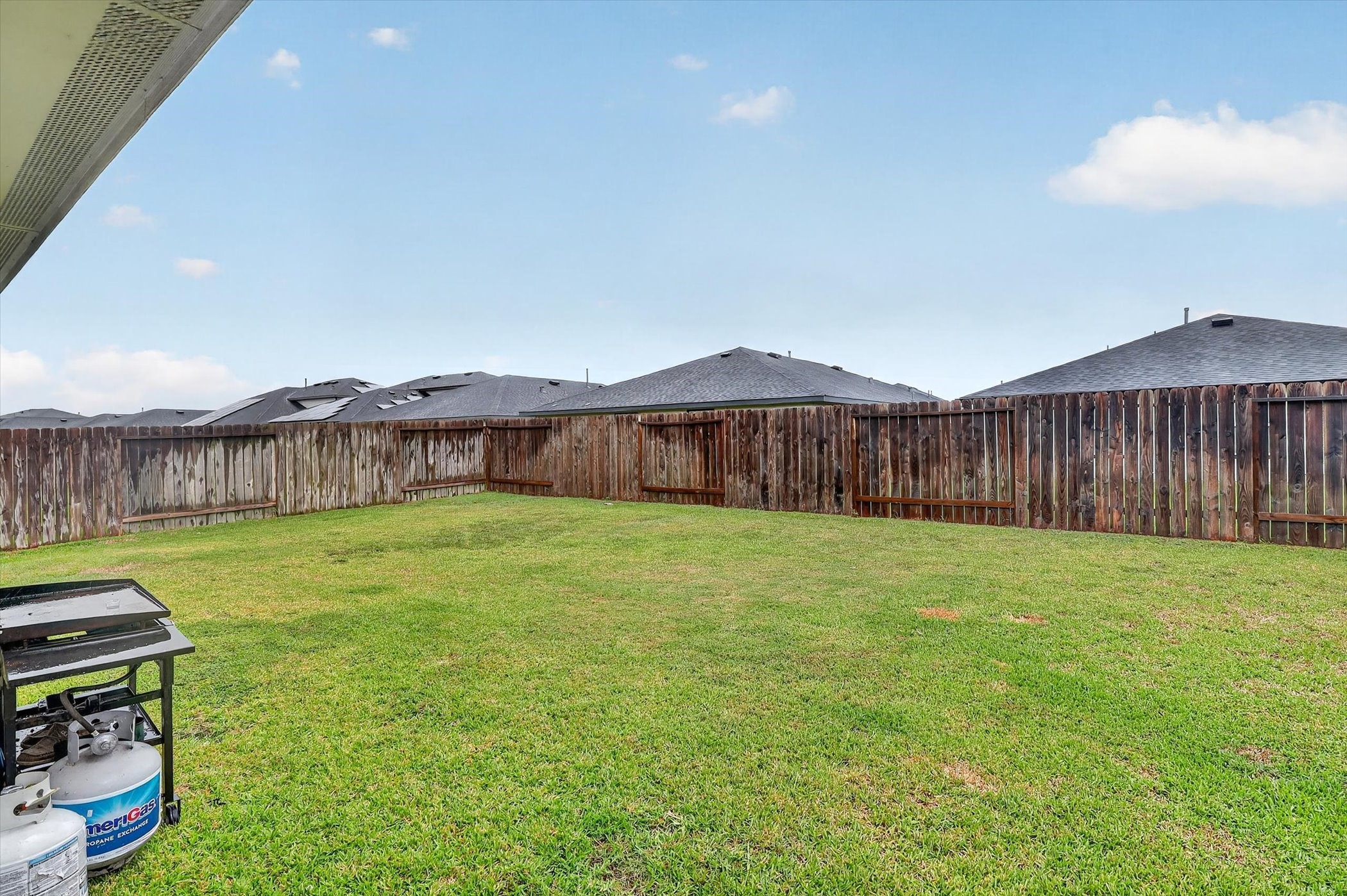 7907 Sleek Flock Lane Rosharon, TX 77583 - Photo 27 of 28 The fully fenced backyard offers plenty of open lawn without dictating how you use it—there’s room for pets, play, gardening, entertaining or a future outdoor setup.