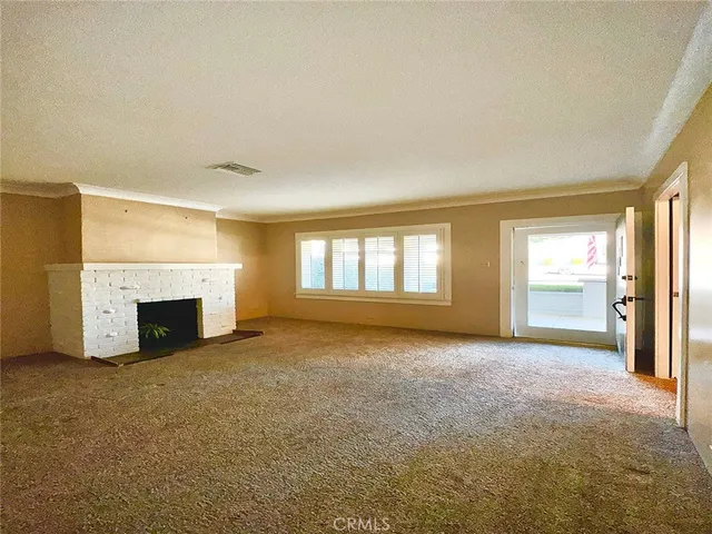 a view of empty room with a fireplace