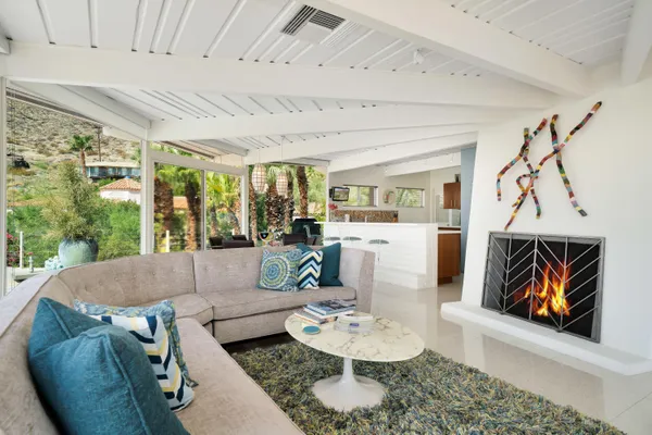 a living room with lots of furniture and a chandelier