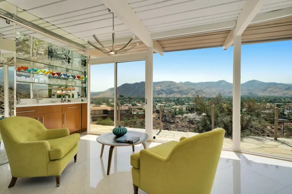 a view of a living room with a table and chairs