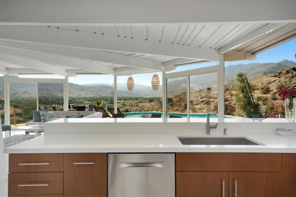 a kitchen with kitchen island a counter top space cabinets and stainless steel appliances