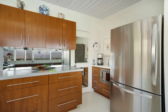 a bedroom with furniture and large windows