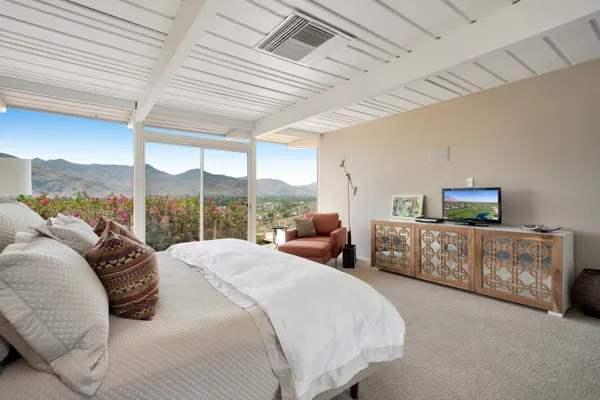 a spacious bathroom with a granite countertop sink mirror and painting on the wall