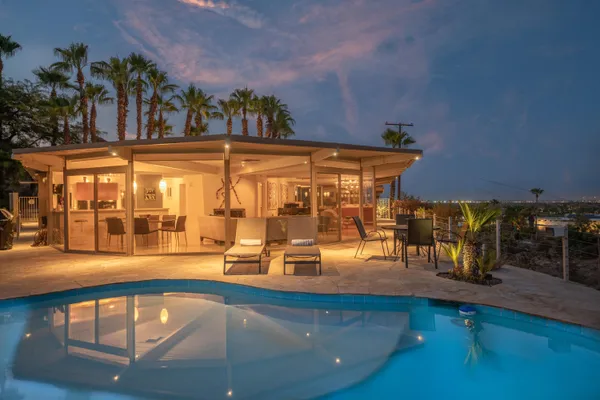 swimming pool view with a outdoor seating