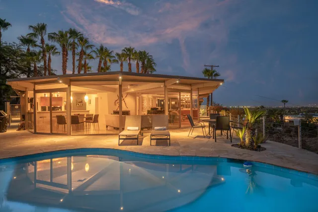 swimming pool view with a outdoor seating