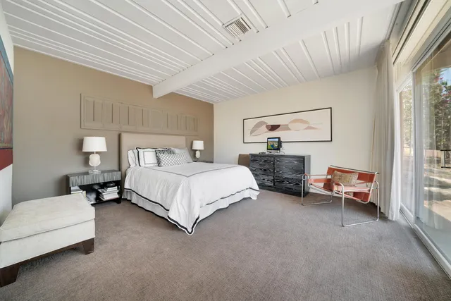 a bedroom with a large bed and a window