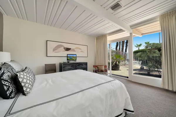 a bathroom with a sink a toilet a mirror and shower